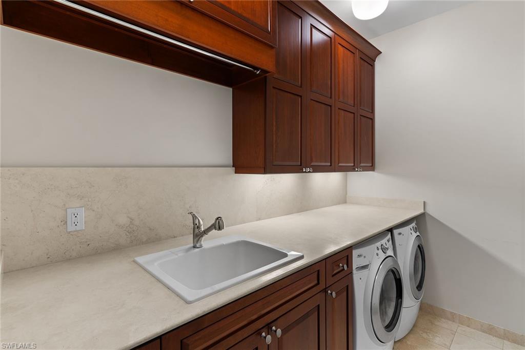 8840 Mariposa Court Naples, FL 34113 - Photo 20 of 50 a utility room with dryer and washer