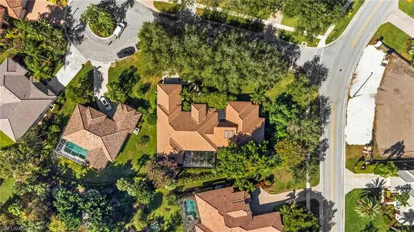 an aerial view of a house with garden space and street view