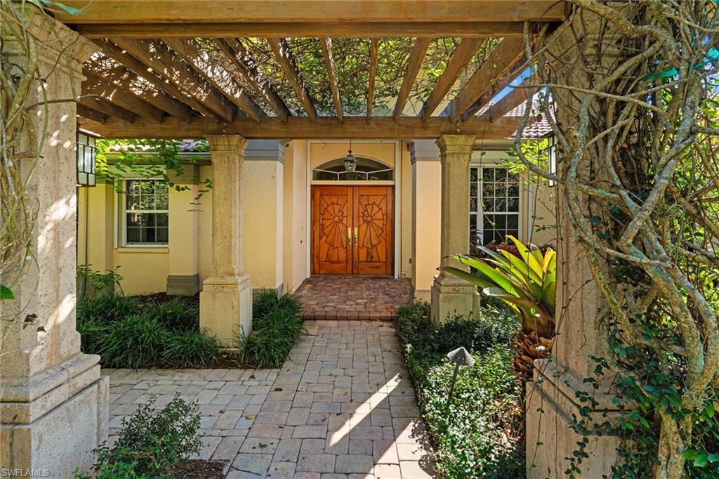 8840 Mariposa Court Naples, FL 34113 - Photo 25 of 50 a front view of a house with a yard
