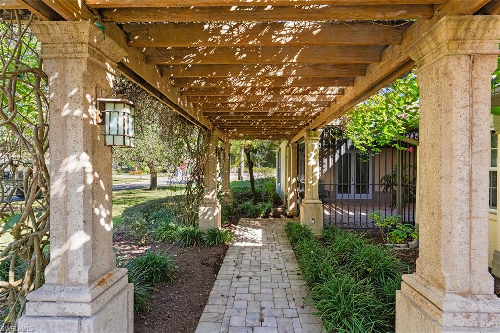 8840 Mariposa Court Naples, FL 34113 - Photo 26 of 50 a front view of a house with a garden