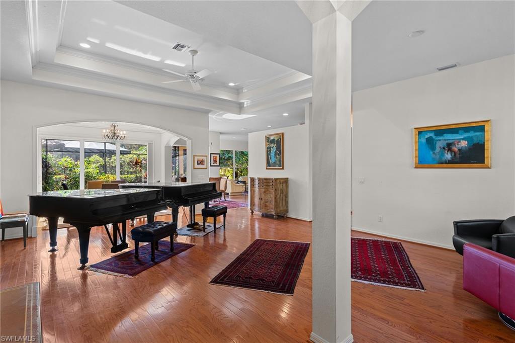 8840 Mariposa Court Naples, FL 34113 - Photo 27 of 50 a living room with furniture and a wooden floor
