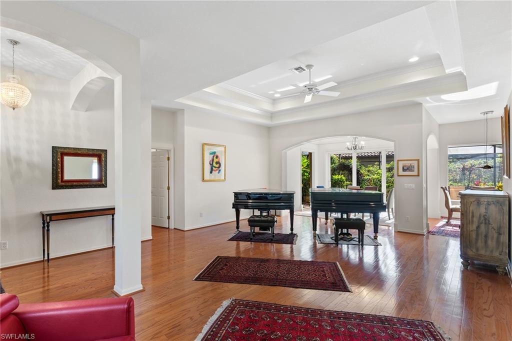 8840 Mariposa Court Naples, FL 34113 - Photo 28 of 50 a view of a livingroom with furniture window and wooden floor