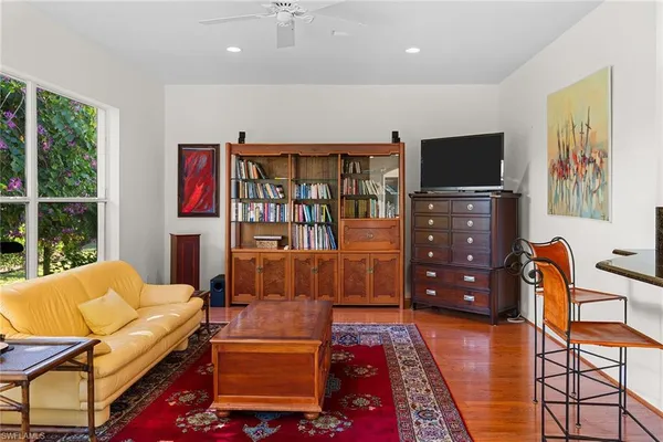 a kitchen with stainless steel appliances granite countertop a refrigerator a stove and a sink with wooden floor