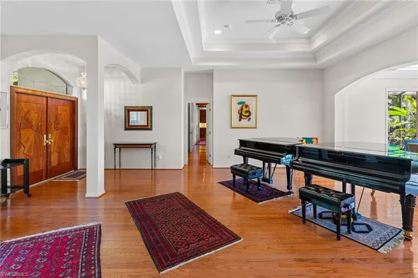 a living room with furniture and a book shelf