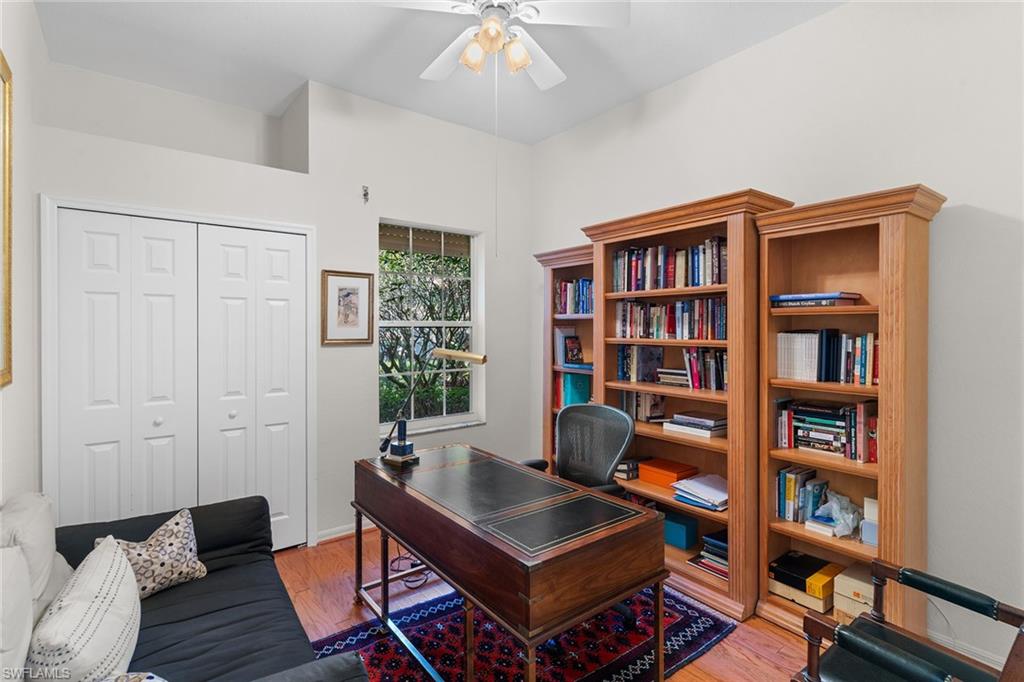 8840 Mariposa Court Naples, FL 34113 - Photo 37 of 50 a living room with furniture and a book shelf