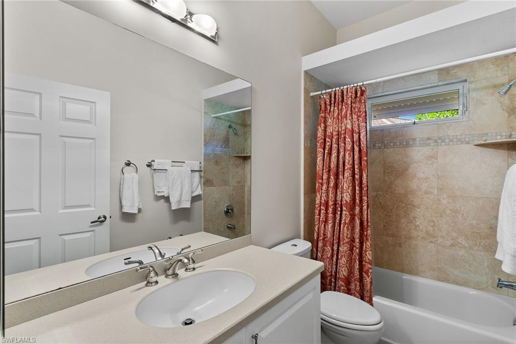 8840 Mariposa Court Naples, FL 34113 - Photo 47 of 50 a bathroom with a sink toilet and shower