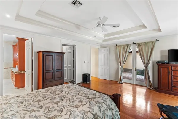 a bedroom with a bed and a large window with the outer view