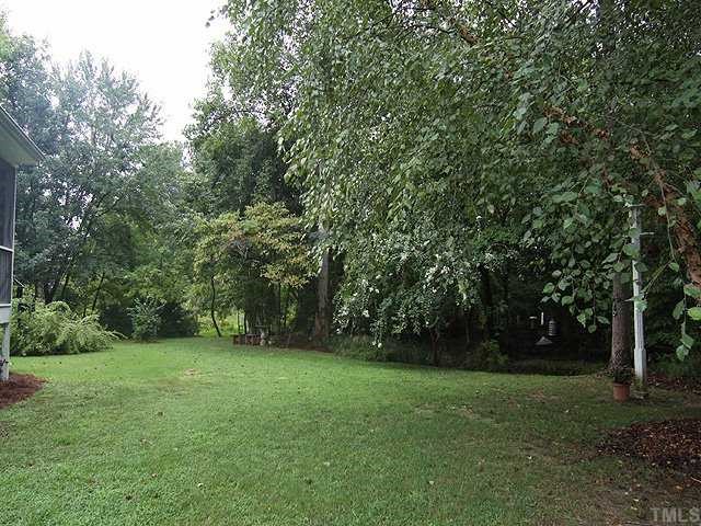10713 Durant Road Raleigh, NC 27615 - Photo 11 of 12 a view of a grassy field with trees