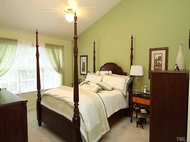 10713 Durant Road Raleigh, NC 27615 - Photo 6 of 12 a bedroom with a bed and a night stand
