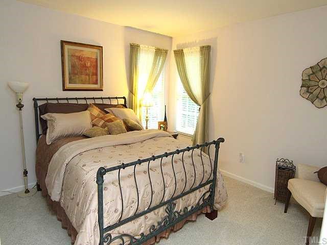 10713 Durant Road Raleigh, NC 27615 - Photo 9 of 12 a bedroom with a bed and a window