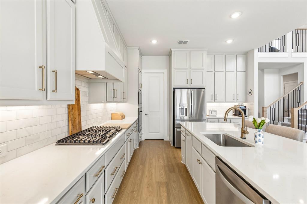 3004 Windy Rdg Road McKinney, TX 75071 - Photo 6 of 40 a kitchen with kitchen island a sink stove and refrigerator