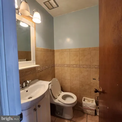 a bathroom with a sink and mirror with toilet