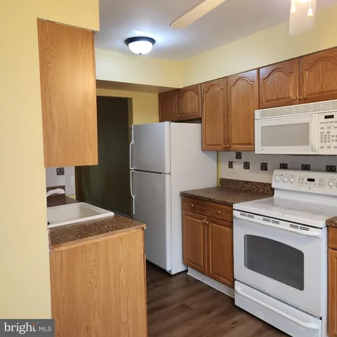 a kitchen with a stove a refrigerator and a sink
