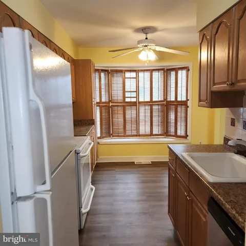 a spacious bathroom with a granite countertop tub and a large window