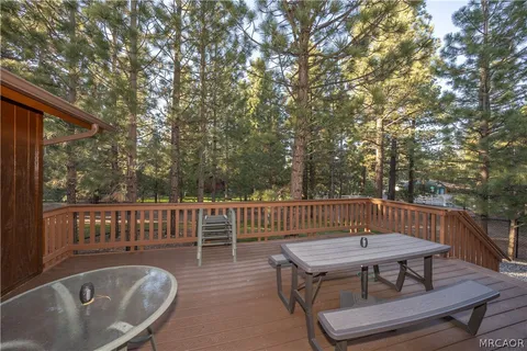 a view of a chairs and table on the roof deck
