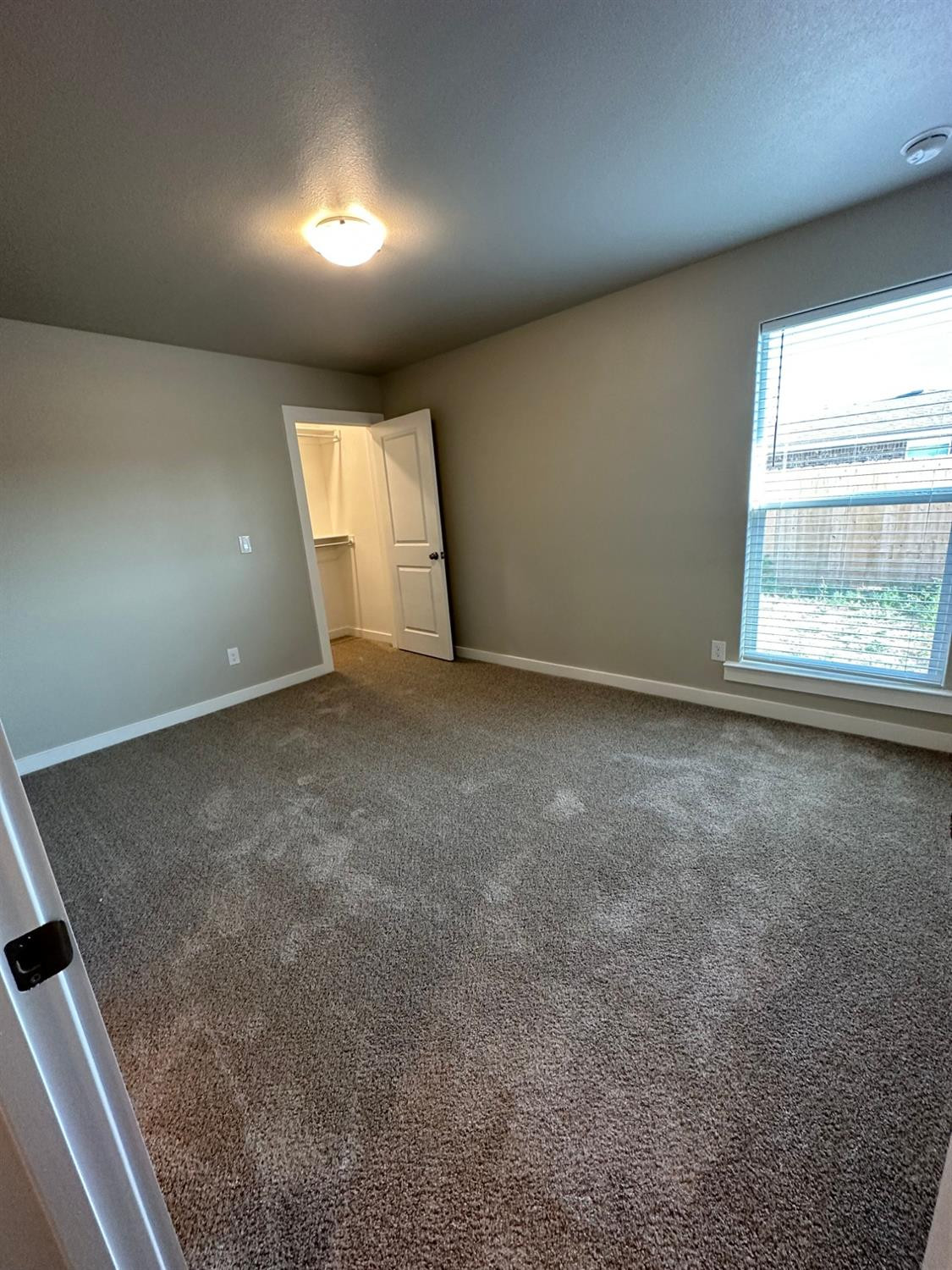1604 135th Street Lubbock, TX 79423 - Photo 13 of 15 an empty room with a empty space and windows