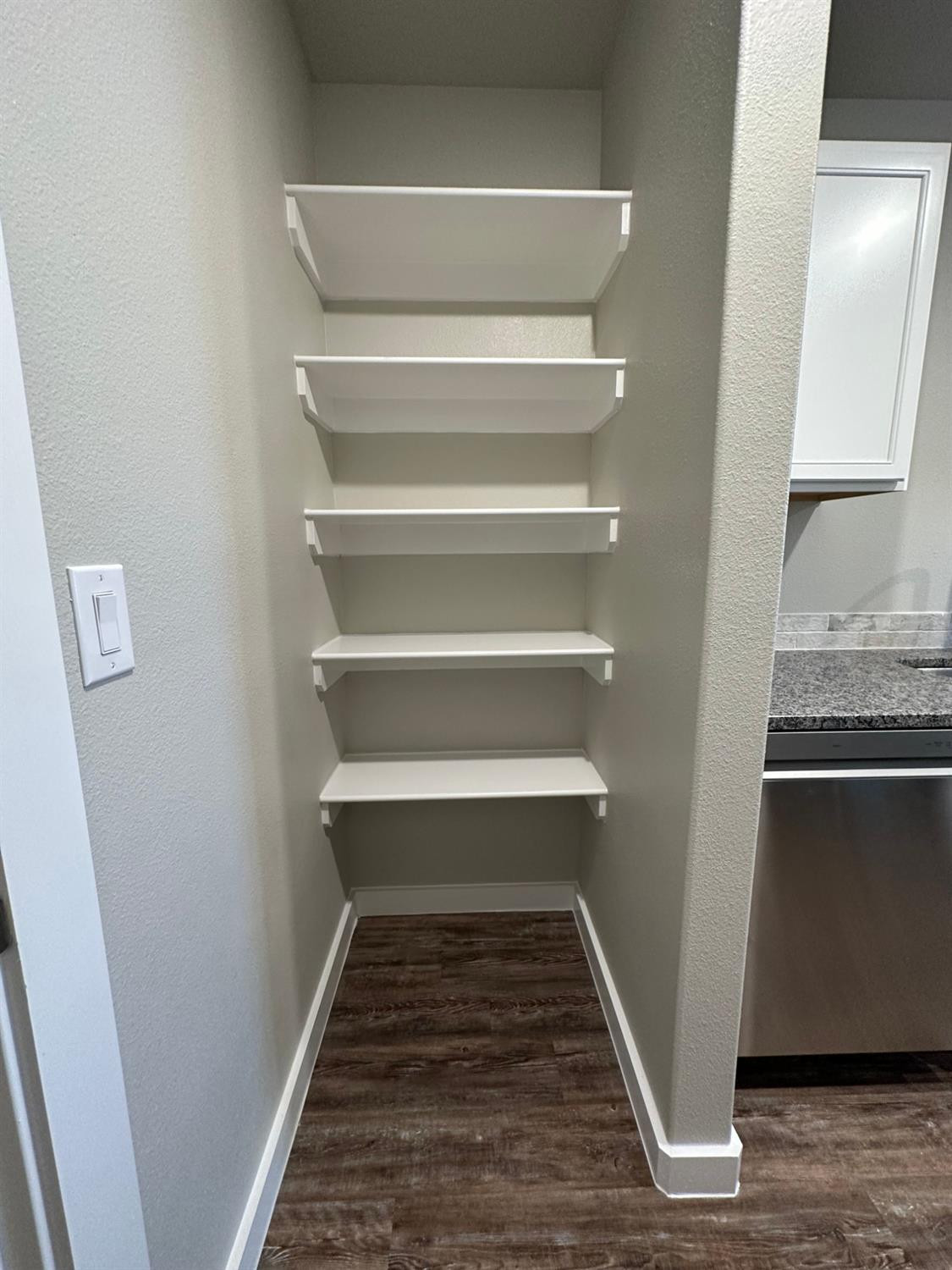 1604 135th Street Lubbock, TX 79423 - Photo 6 of 15 a view of a hallway with wooden floor and a sink