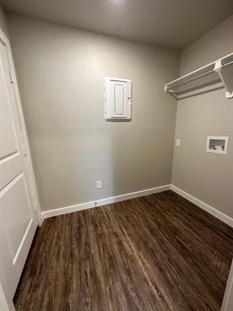 a view of a room with wooden floor and window