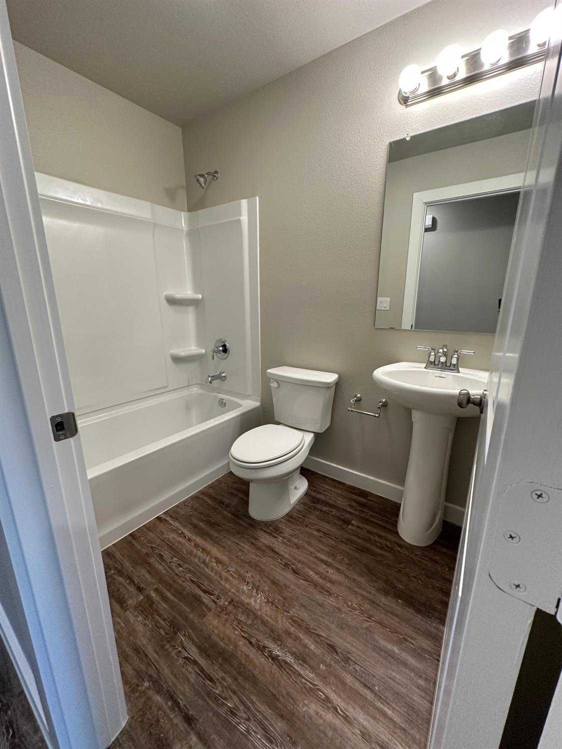1604 135th Street Lubbock, TX 79423 - Photo 9 of 15 a bathroom with a sink a toilet and shower