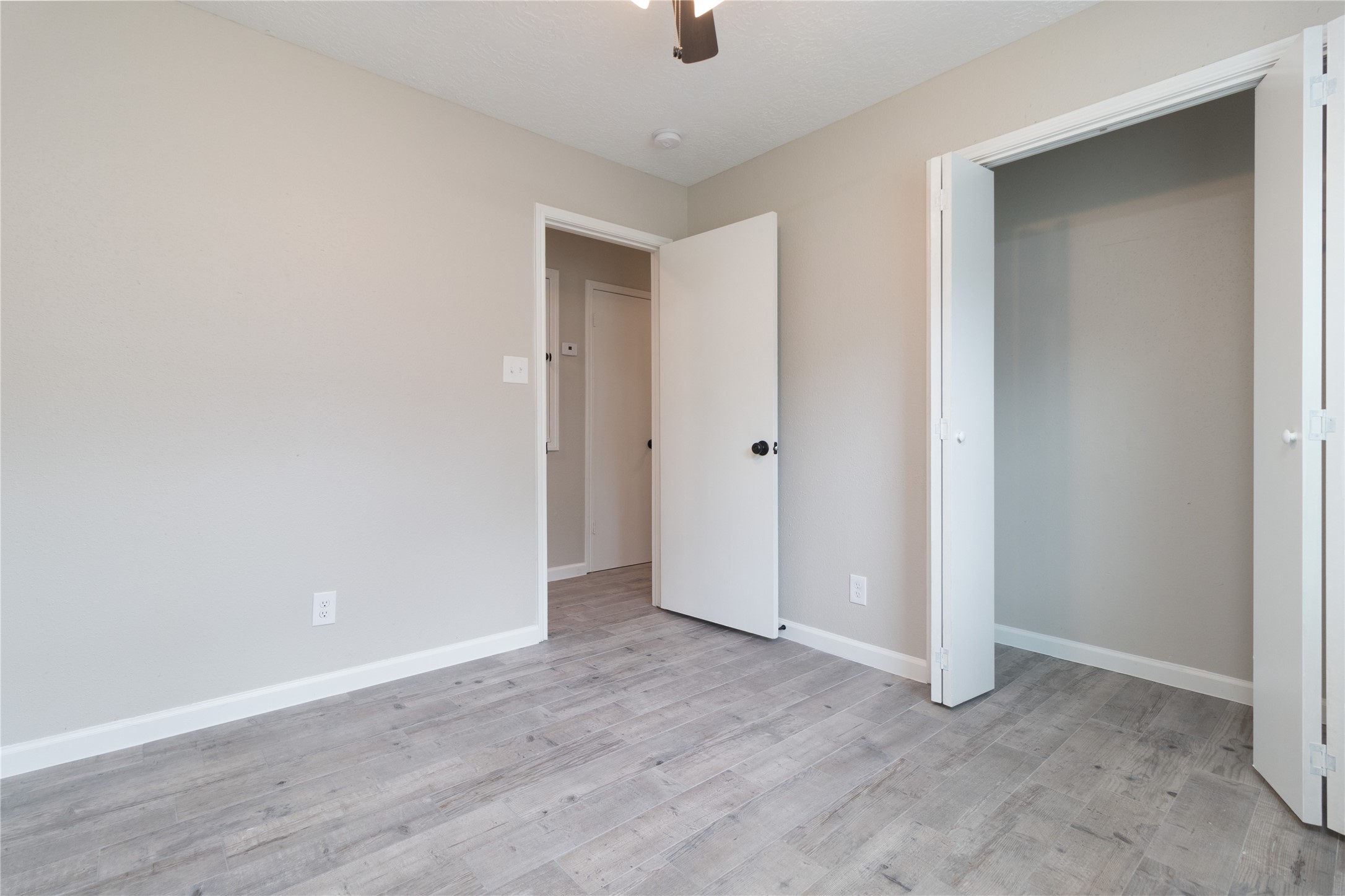 9603 Seeker Street Houston, TX 77078 - Photo 13 of 21 a view of an empty room with wooden floor