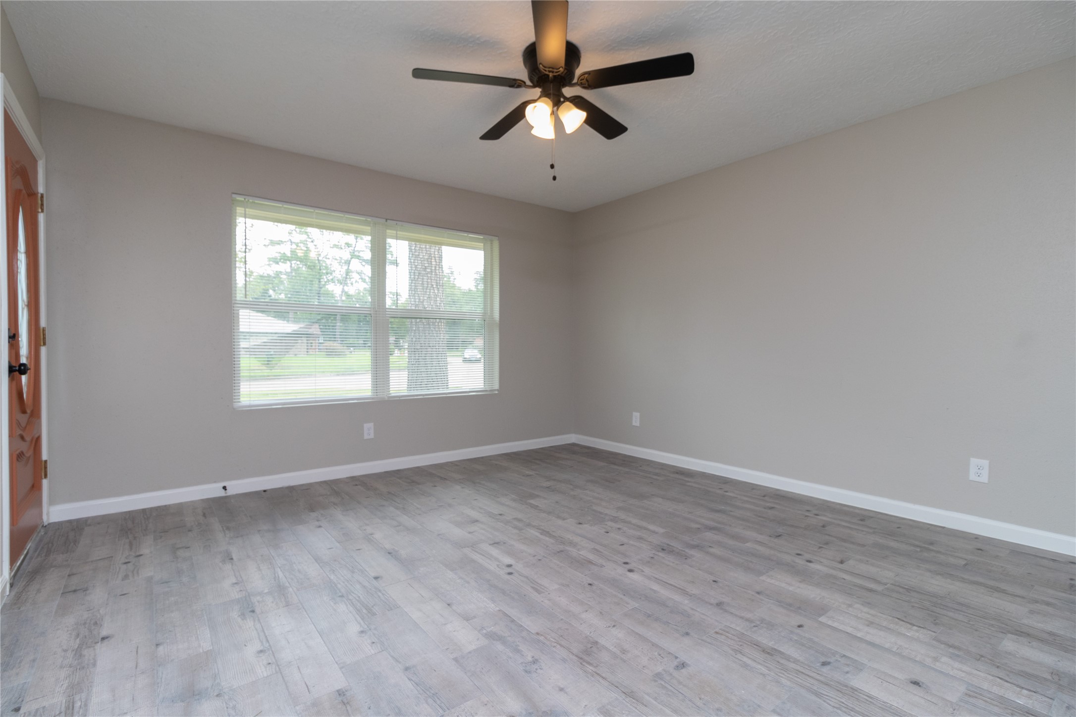 9603 Seeker Street Houston, TX 77078 - Photo 4 of 21 wooden floor in an empty room with a window