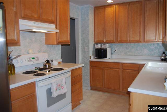 1105 Stewart Street Reno, NV 89502 - Photo 3 of 6 a kitchen with stainless steel appliances granite countertop a sink stove and cabinets