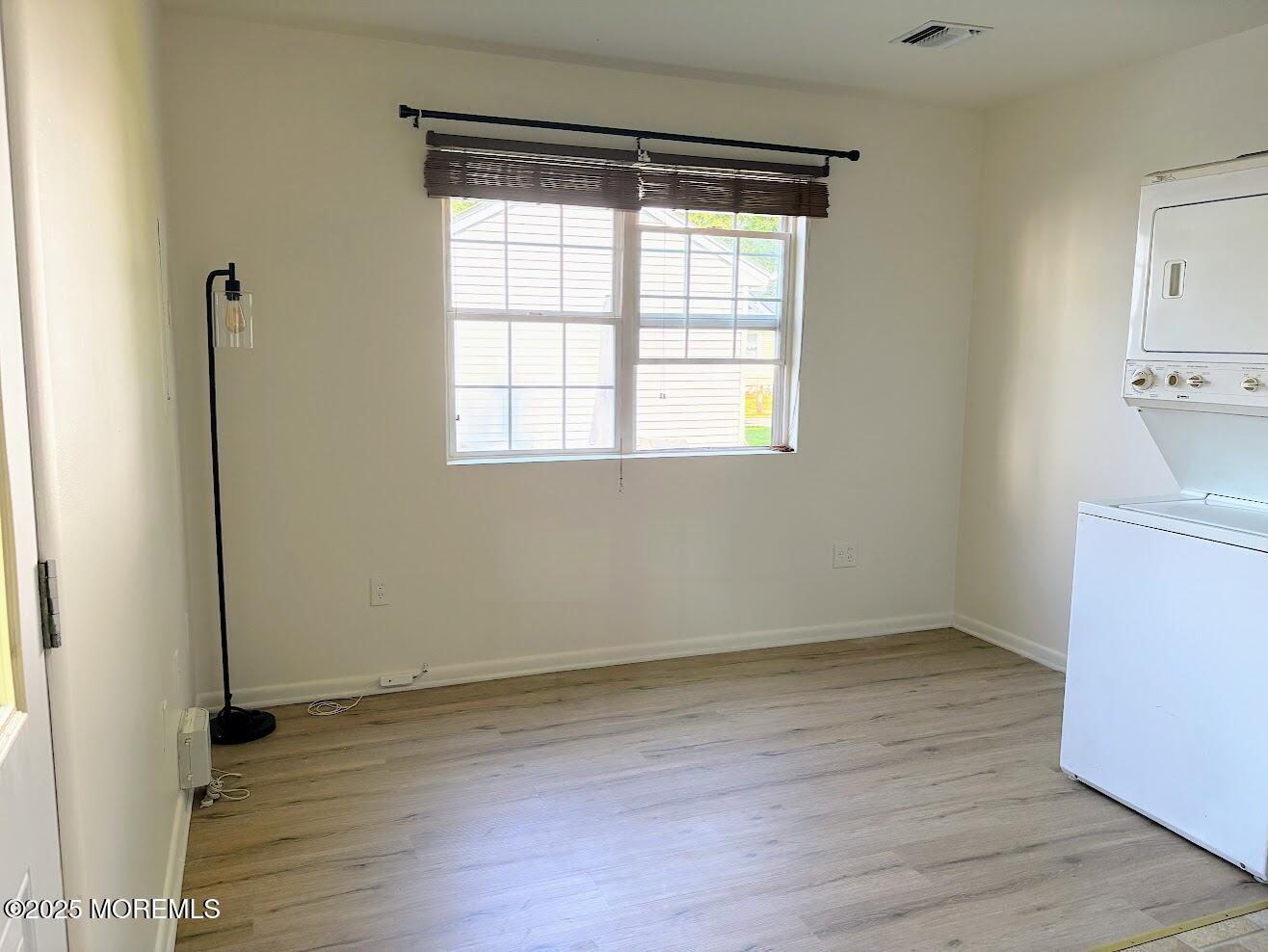 548 Clark Avenue, Unit B Union Beach, NJ 07735 - Photo 3 of 7 an empty room with wooden floor and windows