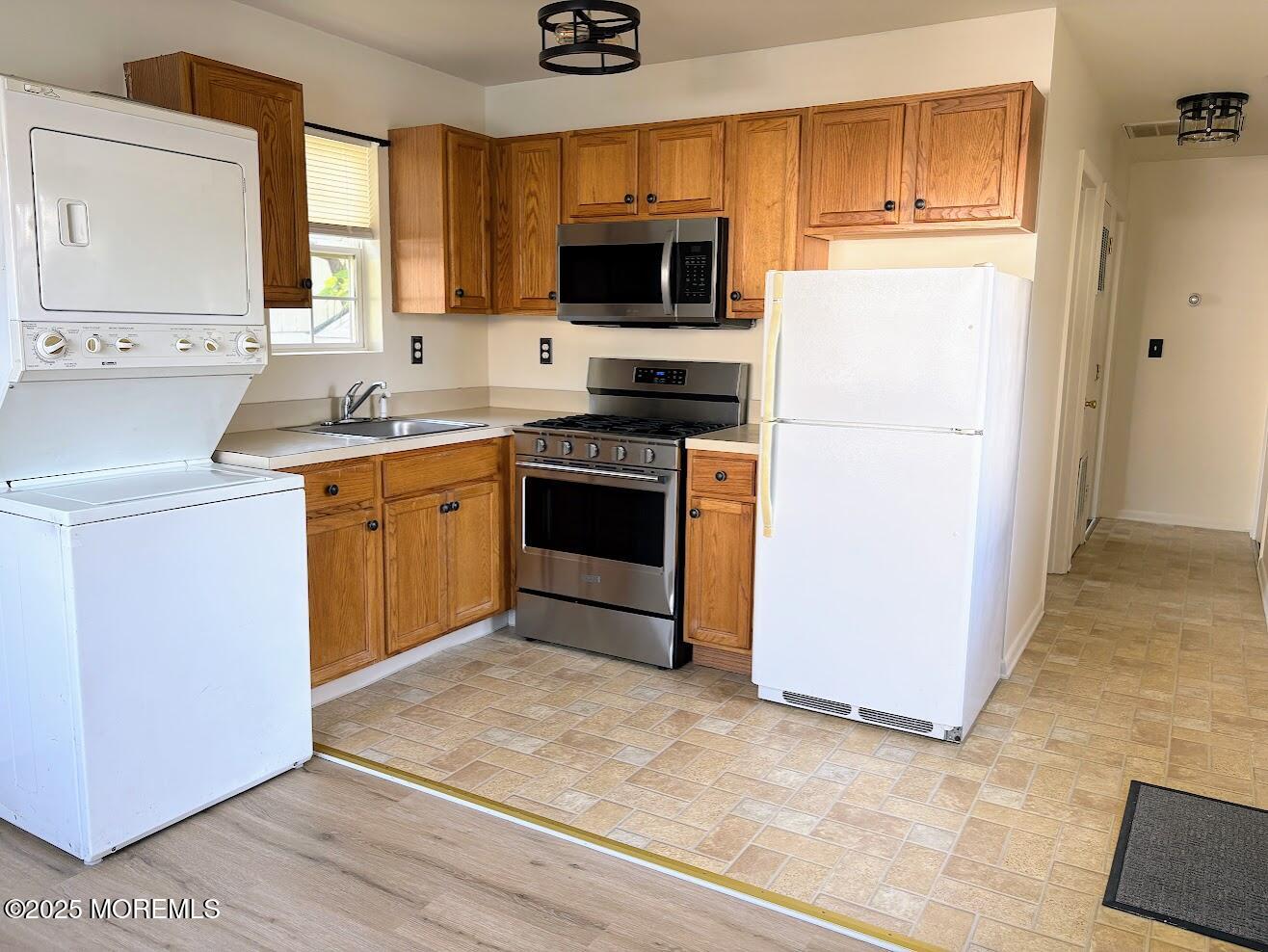 548 Clark Avenue, Unit B Union Beach, NJ 07735 - Photo 4 of 7 a kitchen with stainless steel appliances granite countertop a stove a sink and a refrigerator