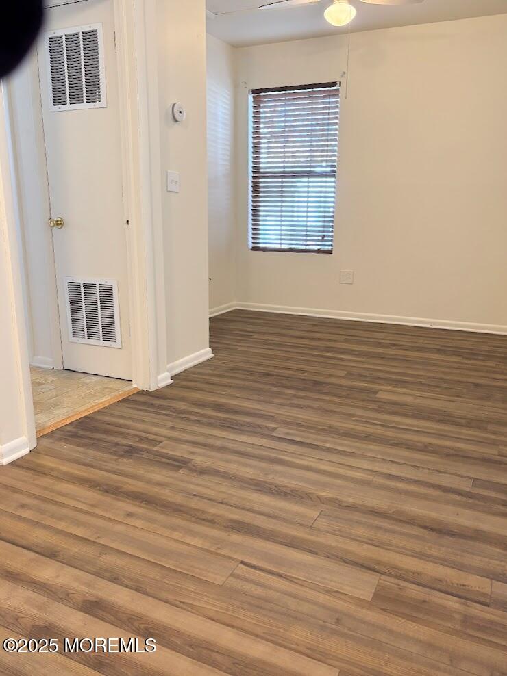 548 Clark Avenue, Unit B Union Beach, NJ 07735 - Photo 7 of 7 a view of an empty room with wooden floor and a window