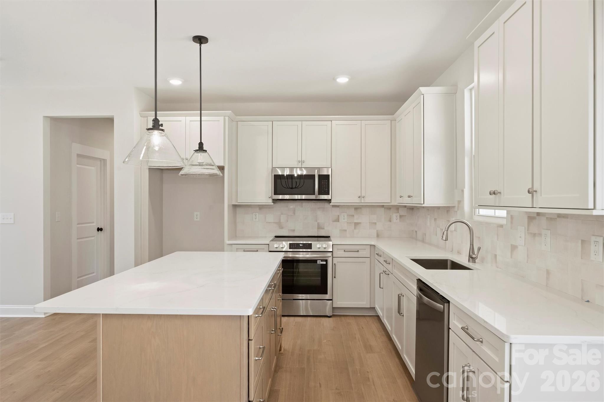 2279 Lee Lawing Road Lincolnton, NC 28092 - Photo 13 of 41 a kitchen with granite countertop a sink a counter space appliances and cabinets