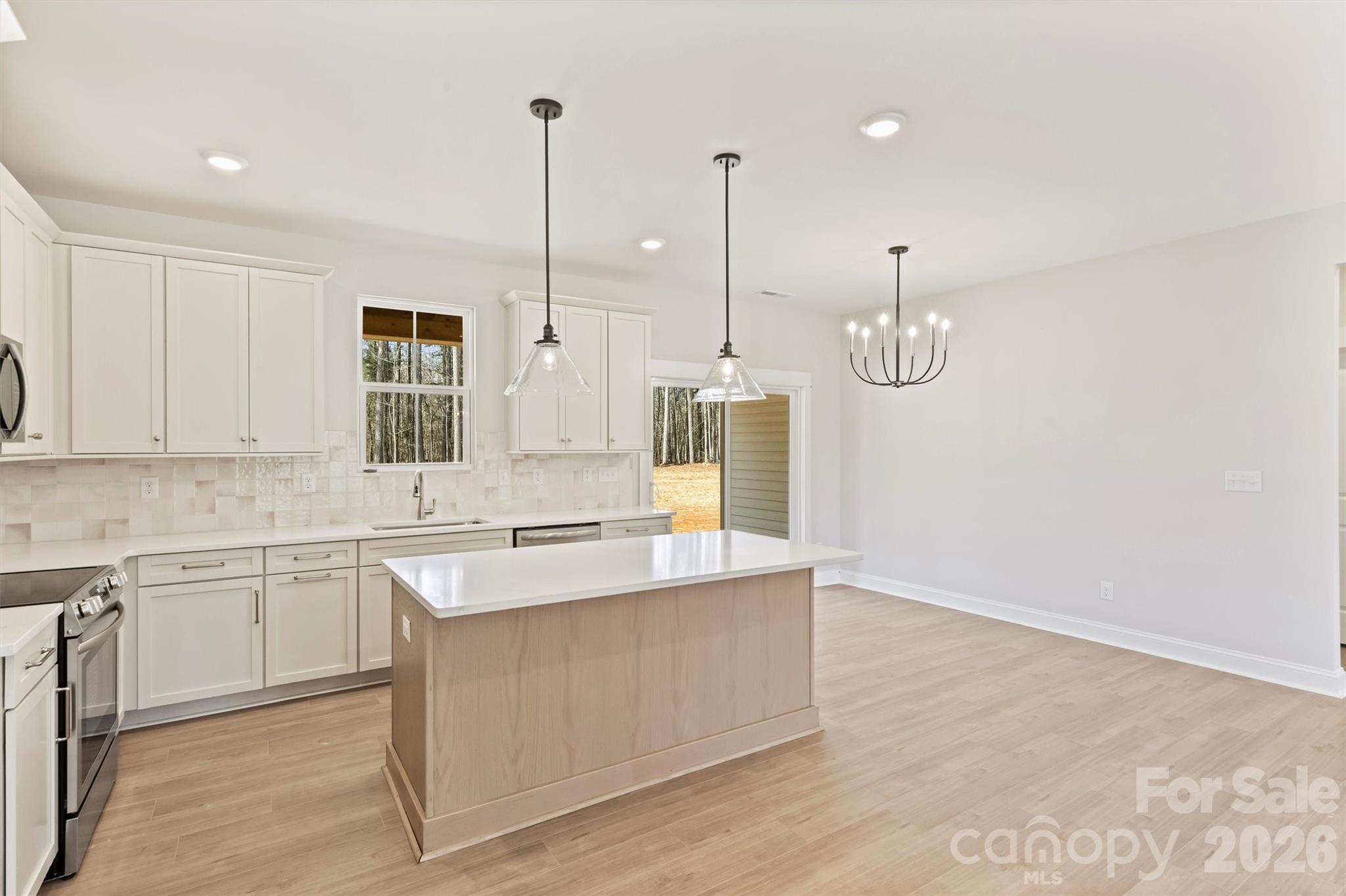 2279 Lee Lawing Road Lincolnton, NC 28092 - Photo 15 of 41 a kitchen with stainless steel appliances granite countertop cabinets a sink a window and chairs