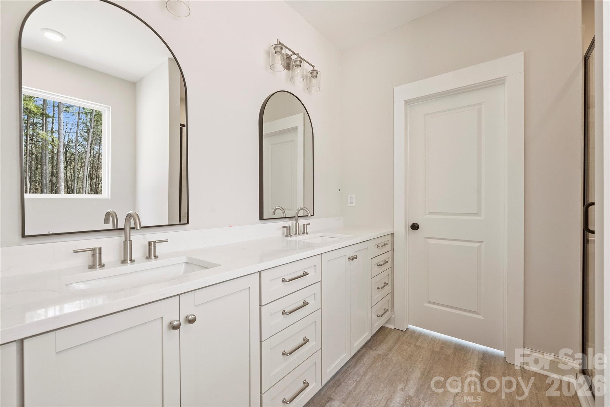 2279 Lee Lawing Road Lincolnton, NC 28092 - Photo 22 of 41 a bathroom with double vanity sink a two mirror a window and vanity