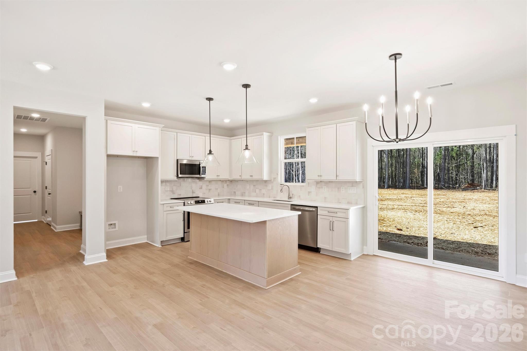 2279 Lee Lawing Road Lincolnton, NC 28092 - Photo 9 of 41 a large kitchen with granite countertop a stove a sink and a refrigerator