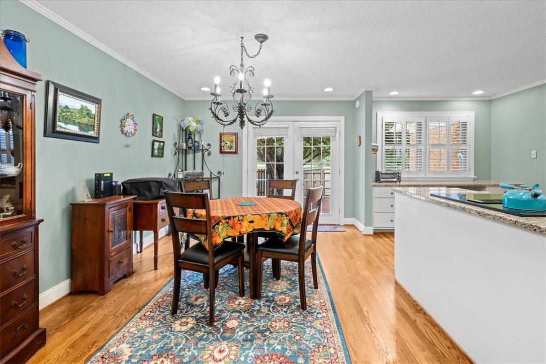 2004 Cardinal Park Drive Anderson, SC 29621 - Photo 14 of 40 Hardwood floors and a classic chandelier define this open dining area adjacent to the kitchen.