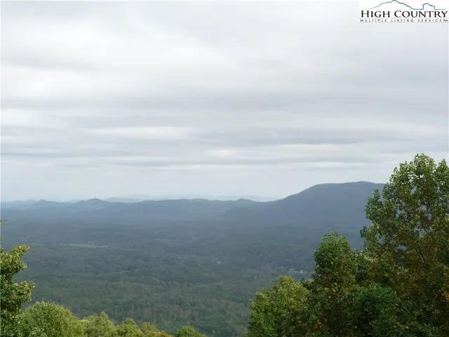 a view of backyard with a table and chairs