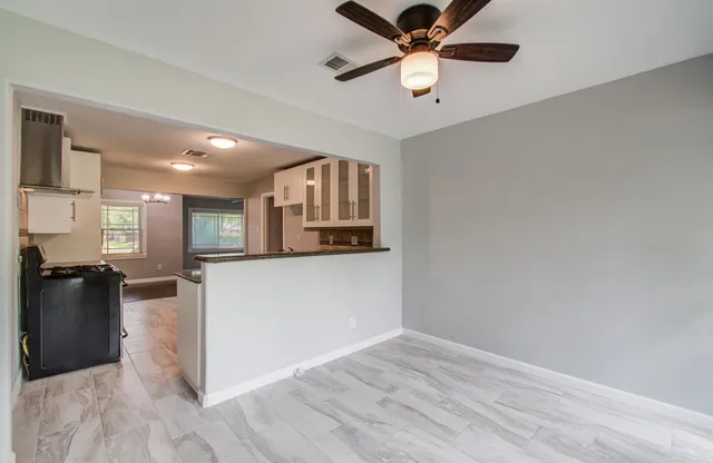 a view of a living room hardwood and a ceiling fan