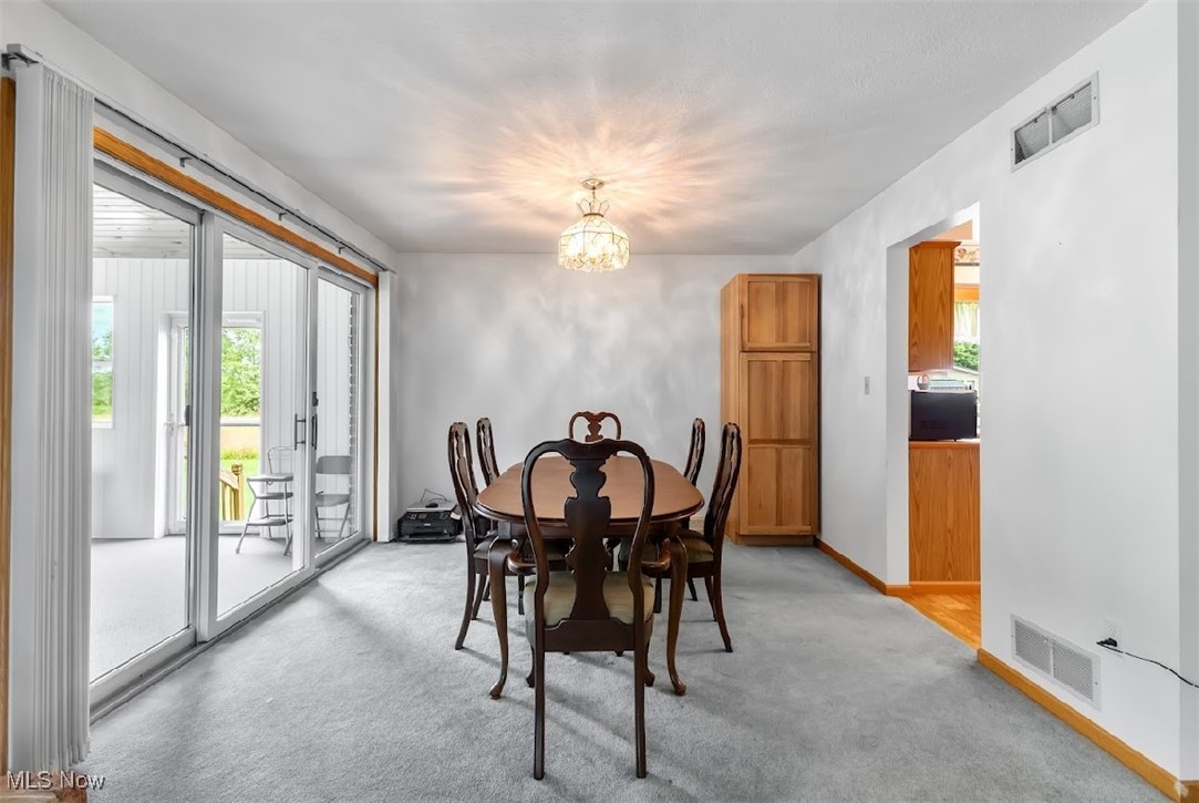 6061 Phillips Rice Road Cortland, OH 44410 - Photo 14 of 34 Carpeted dining space featuring an inviting chandelier