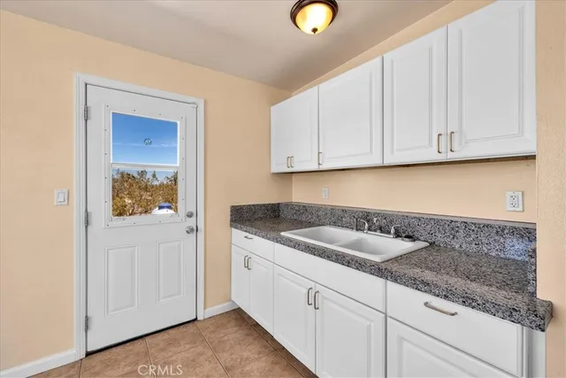 a kitchen with granite countertop a sink