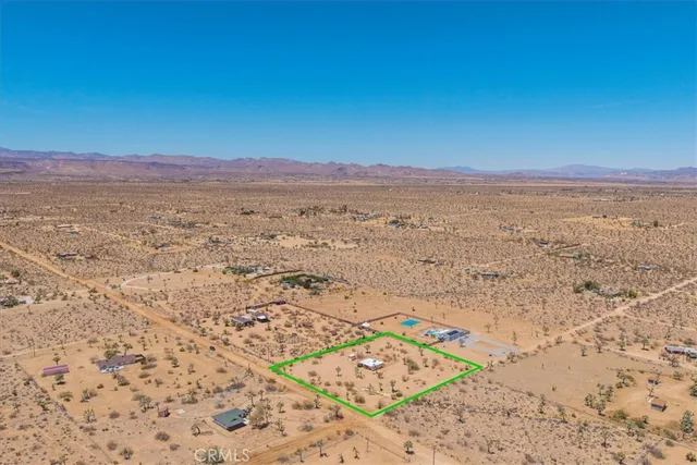 a view of an ocean beach and mountain