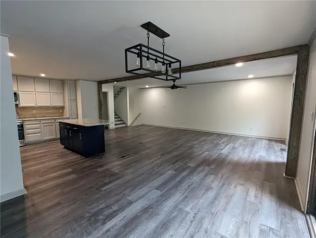 a view of a kitchen with wooden floor and a sink