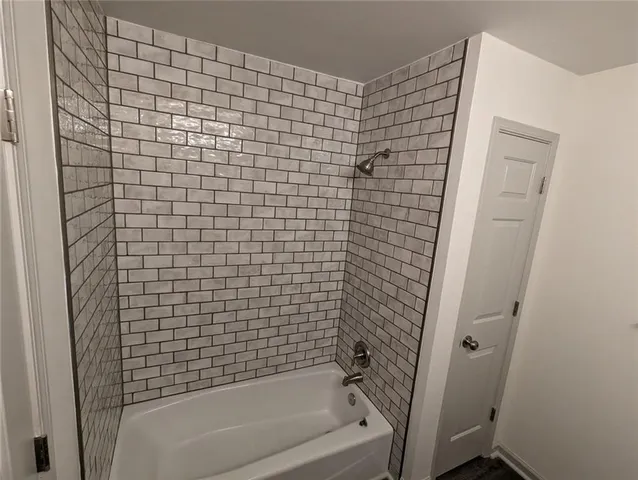 a bathroom with a bathtub and shower
