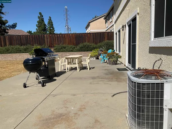 a view of a backyard with furniture and a grill