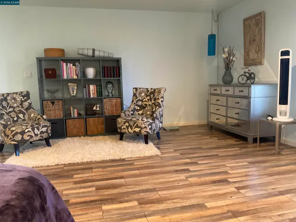 a bedroom with furniture and a wooden floor