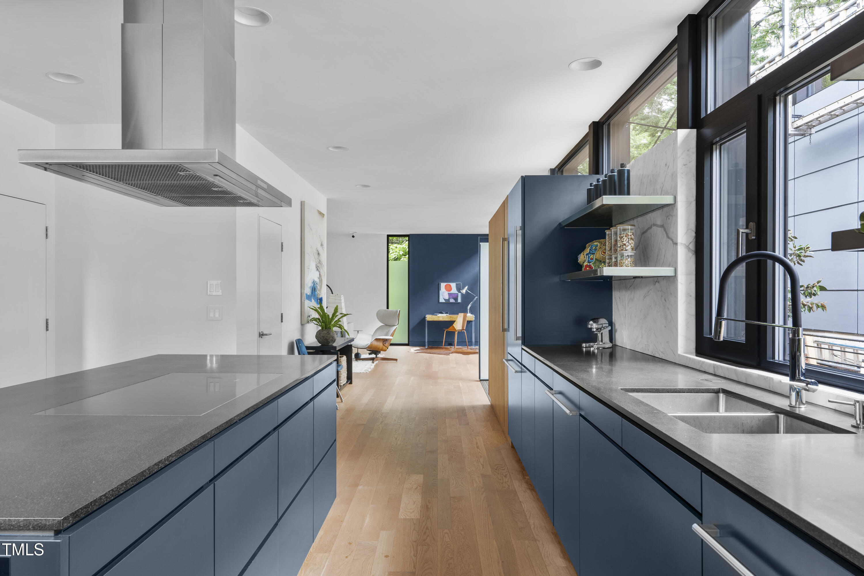 922 Tower Street Raleigh, NC 27607 - Photo 19 of 48 a large kitchen with stainless steel appliances a sink and cabinets
