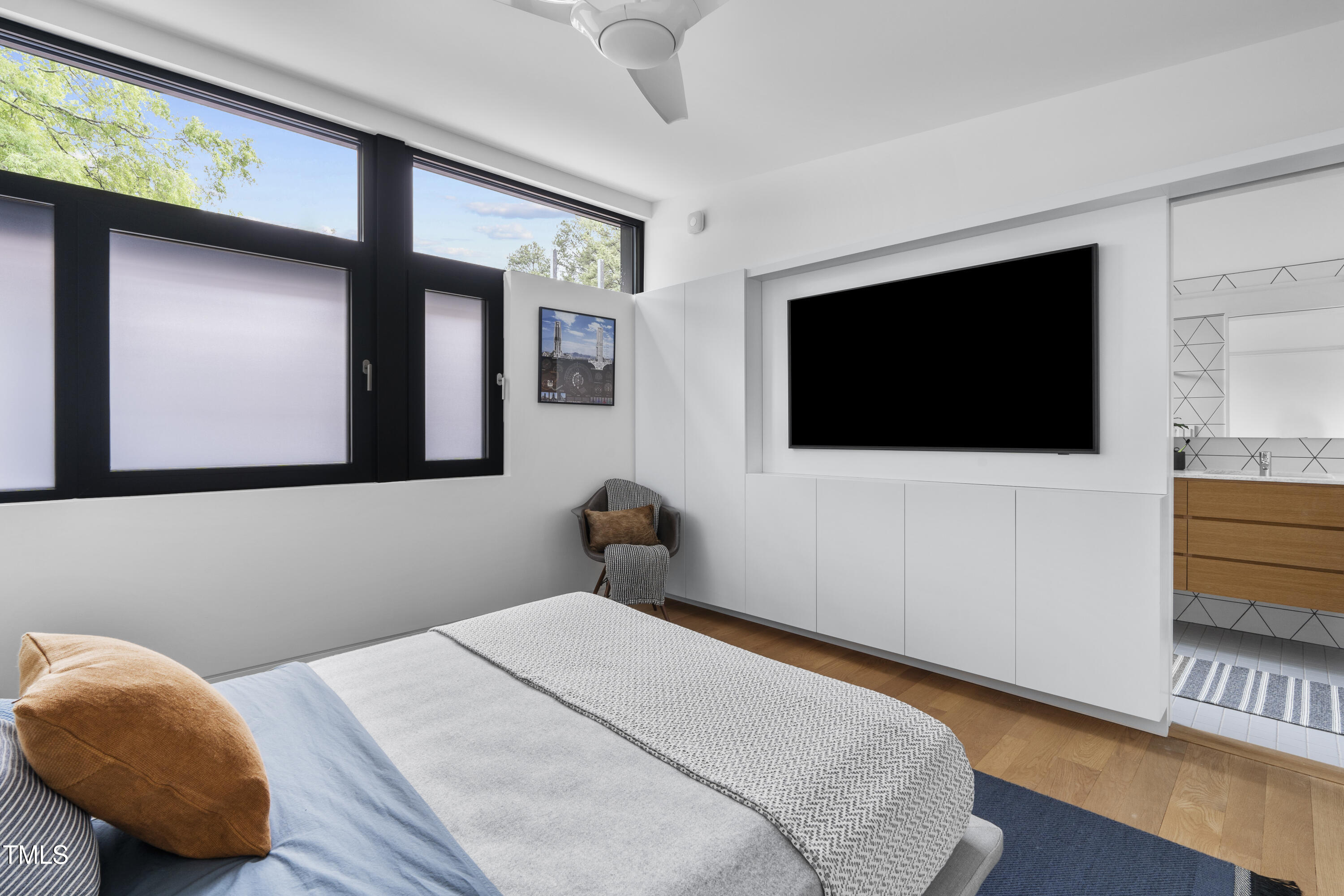 922 Tower Street Raleigh, NC 27607 - Photo 25 of 48 a bedroom with a bed and a flat screen tv