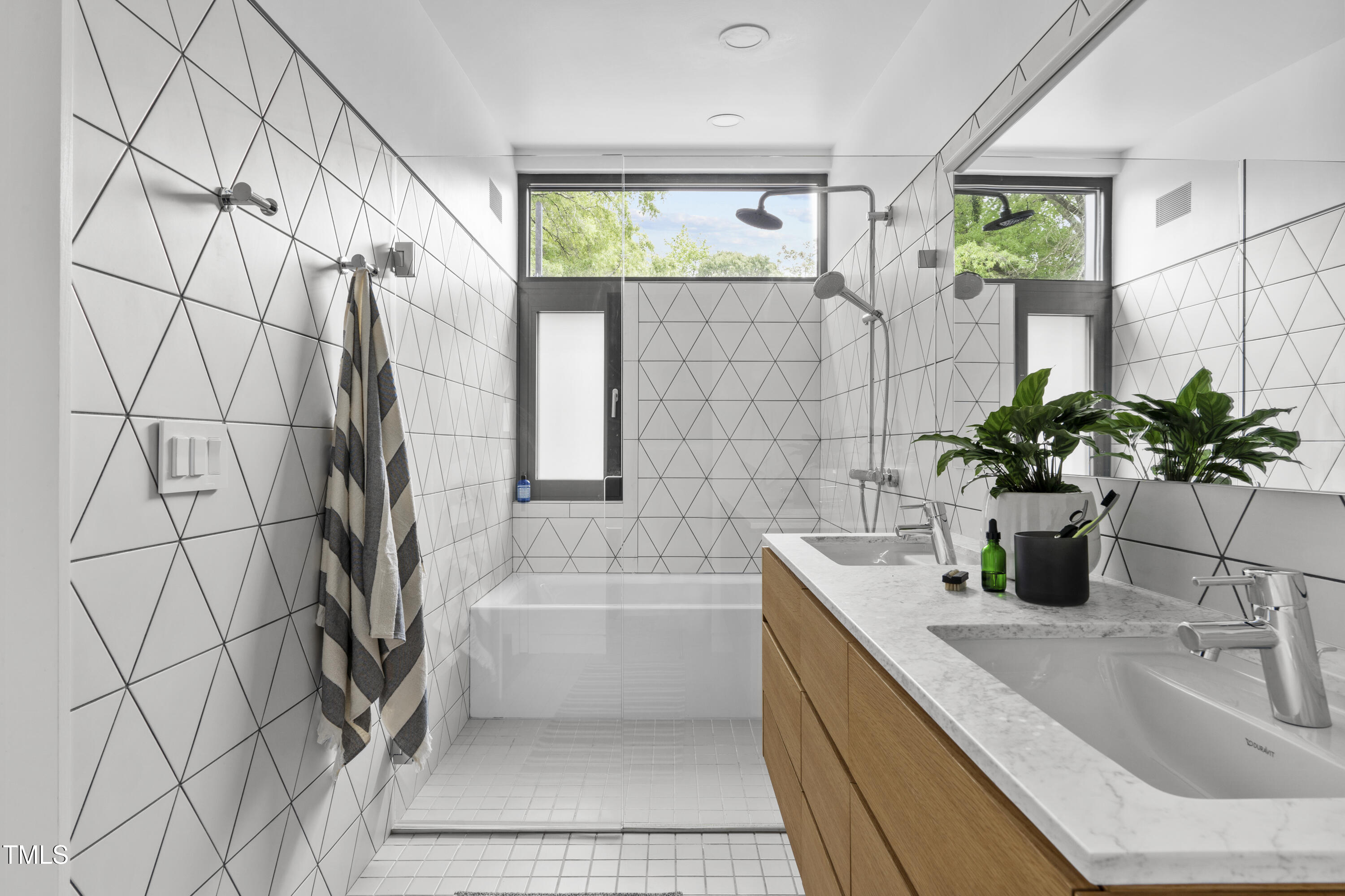 922 Tower Street Raleigh, NC 27607 - Photo 27 of 48 a bathroom with a sink a bathtub and a shower