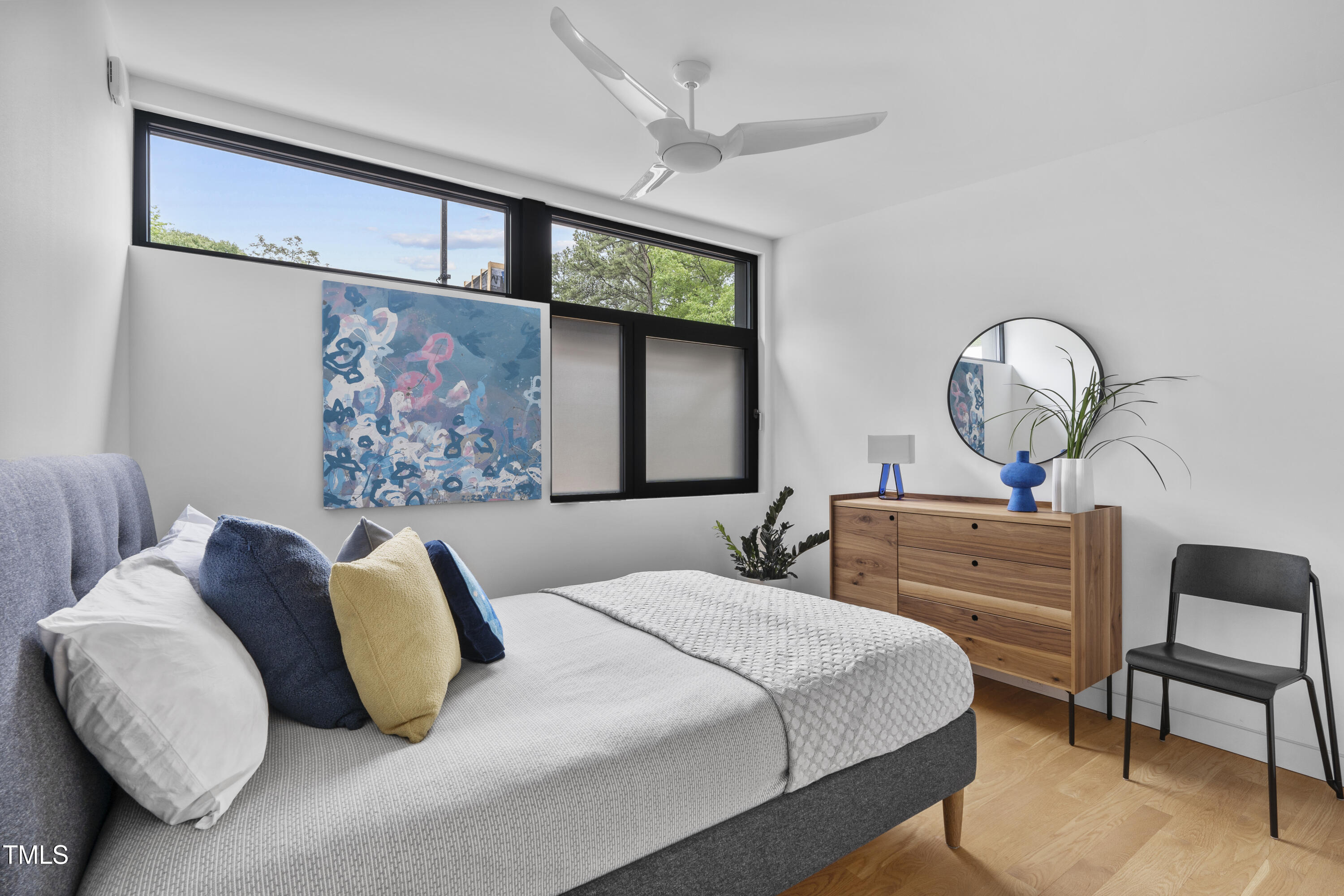 922 Tower Street Raleigh, NC 27607 - Photo 29 of 48 a bedroom with a bed and a chandelier