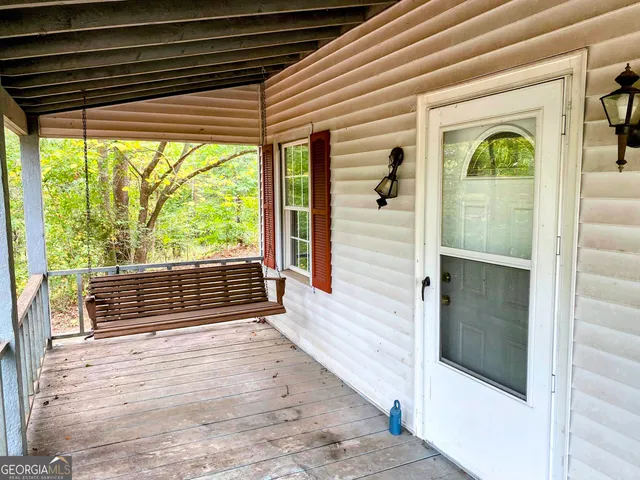 a view of a porch with wooden floor and stairs