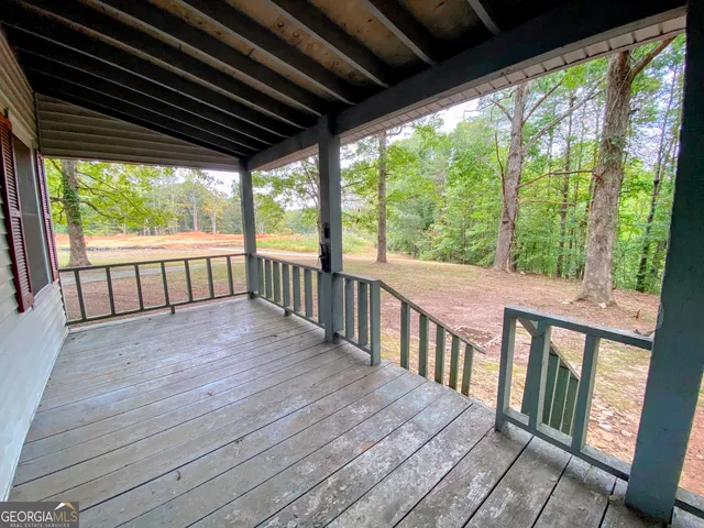 a view of a porch with wooden floor