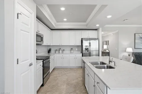a kitchen with refrigerator and furniture